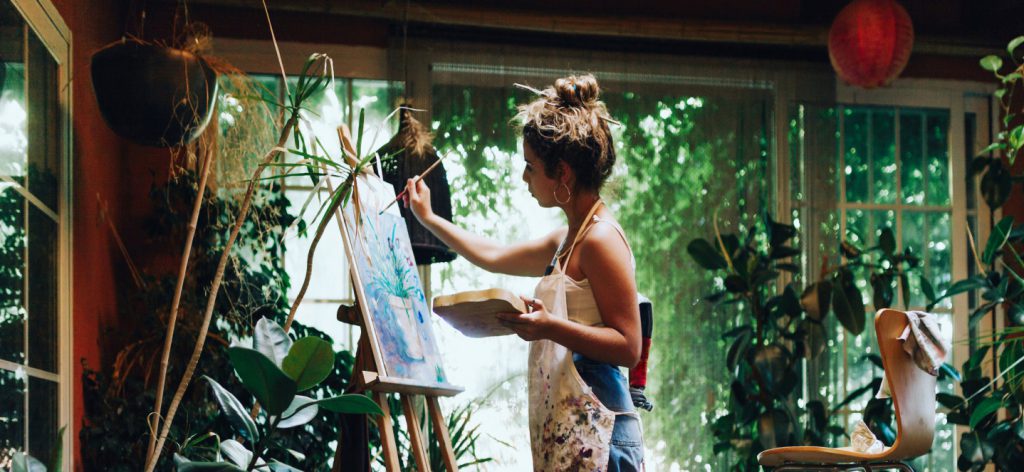 a woman painting outside